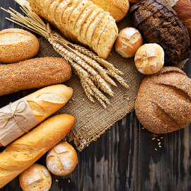 Assortment of baked bread on old wooden  background